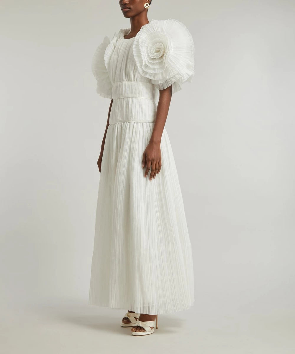 Indulge in raw, untamed beauty with Aje's Expressive Pleated Maxi-Dress. With a pleated fitted-bodice, short-sleeves adorned with voluminous organza ruffles, and an effortlessly relaxed maxi-skirt, this statement piece exudes elegance and sophistication. Embrace the brand's dedication to bold, unconventional style.