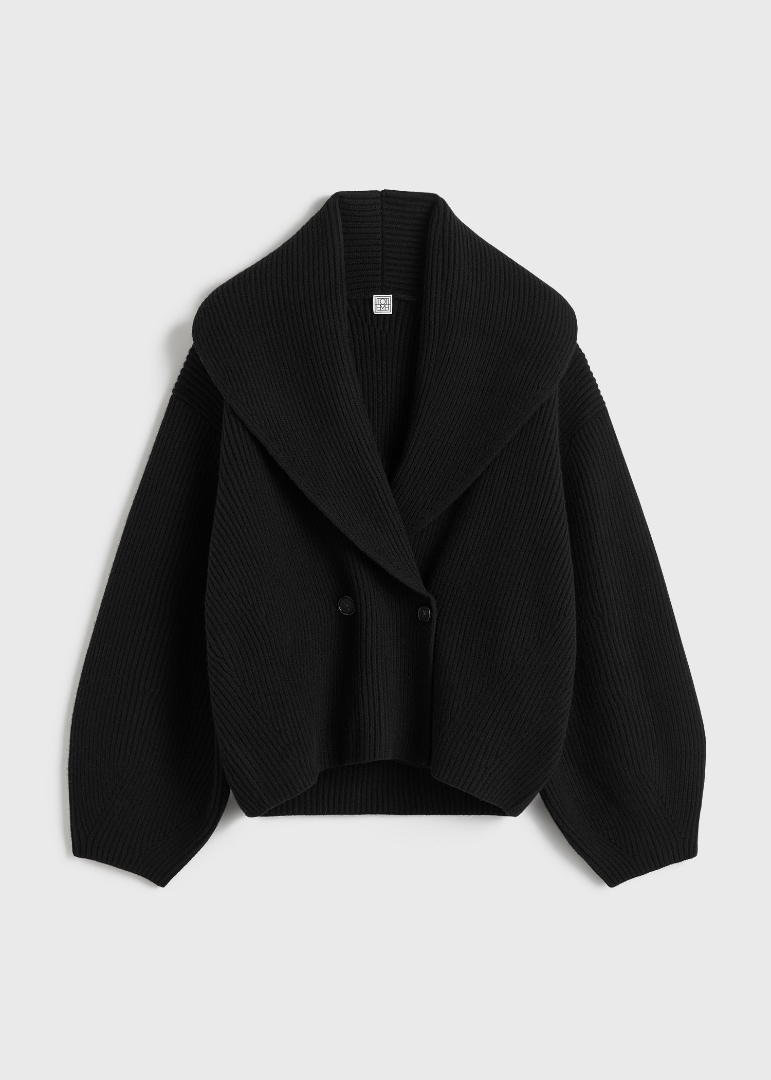 Elevate your layering with this oversized shawl-lapel cardigan in black by Toteme. Crafted from soft ribbed wool, it offers warmth and cozy comfort while its wide armholes and sleeves ensure effortless movement. The crossed front with button fastening adds a stylish, secure fit, and the curved shawl lapels bring a sophisticated touch to any outfit. Perfect for chic, relaxed days or cozy evenings indoors.