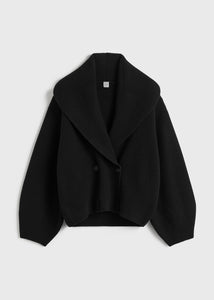 Elevate your layering with this oversized shawl-lapel cardigan in black by Toteme. Crafted from soft ribbed wool, it offers warmth and cozy comfort while its wide armholes and sleeves ensure effortless movement. The crossed front with button fastening adds a stylish, secure fit, and the curved shawl lapels bring a sophisticated touch to any outfit. Perfect for chic, relaxed days or cozy evenings indoors.