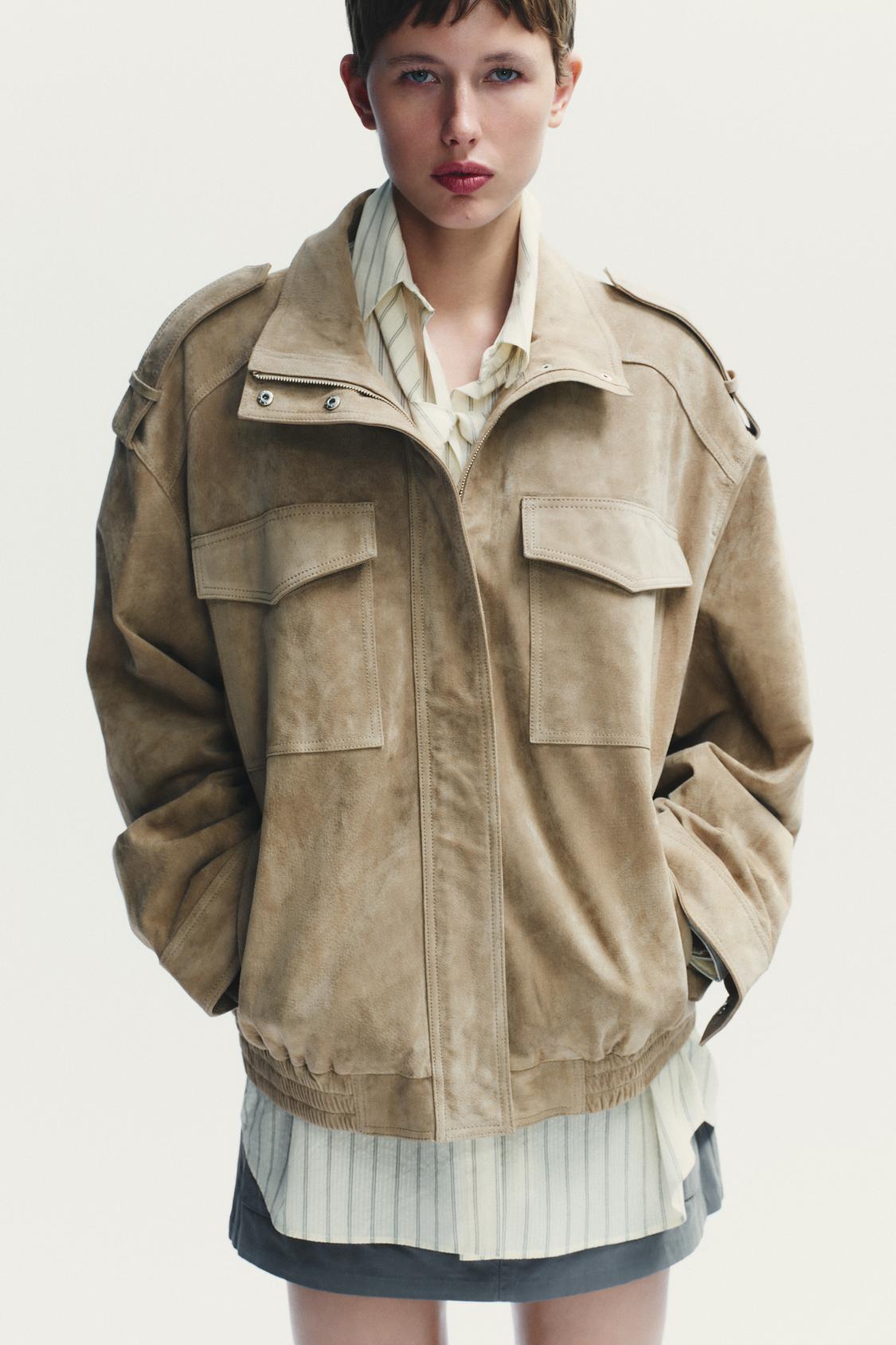 Elevate your style with this Suede Leather Jacket, featuring a high collar for added warmth and sophistication. The long cuffed sleeves with shoulder tabs add a touch of rugged elegance, while front and chest flap pockets combine functionality with fashion. The zip-up front is secured with a snap-button placket, ensuring both convenience and a sleek finish. Perfect for layering, this jacket offers a timeless look that effortlessly enhances any outfit.