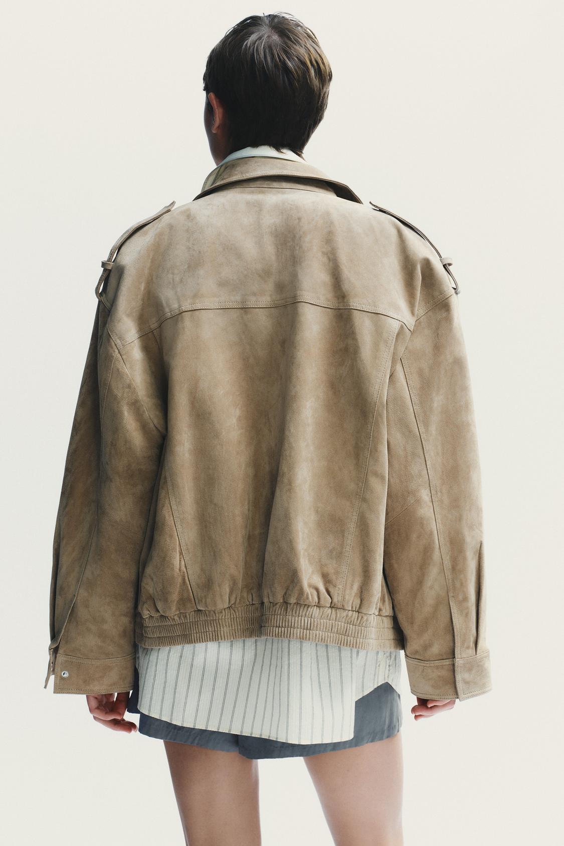 Elevate your style with this Suede Leather Jacket, featuring a high collar for added warmth and sophistication. The long cuffed sleeves with shoulder tabs add a touch of rugged elegance, while front and chest flap pockets combine functionality with fashion. The zip-up front is secured with a snap-button placket, ensuring both convenience and a sleek finish. Perfect for layering, this jacket offers a timeless look that effortlessly enhances any outfit.
