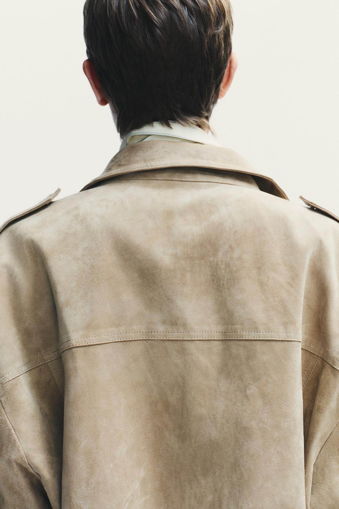 Elevate your style with this Suede Leather Jacket, featuring a high collar for added warmth and sophistication. The long cuffed sleeves with shoulder tabs add a touch of rugged elegance, while front and chest flap pockets combine functionality with fashion. The zip-up front is secured with a snap-button placket, ensuring both convenience and a sleek finish. Perfect for layering, this jacket offers a timeless look that effortlessly enhances any outfit.