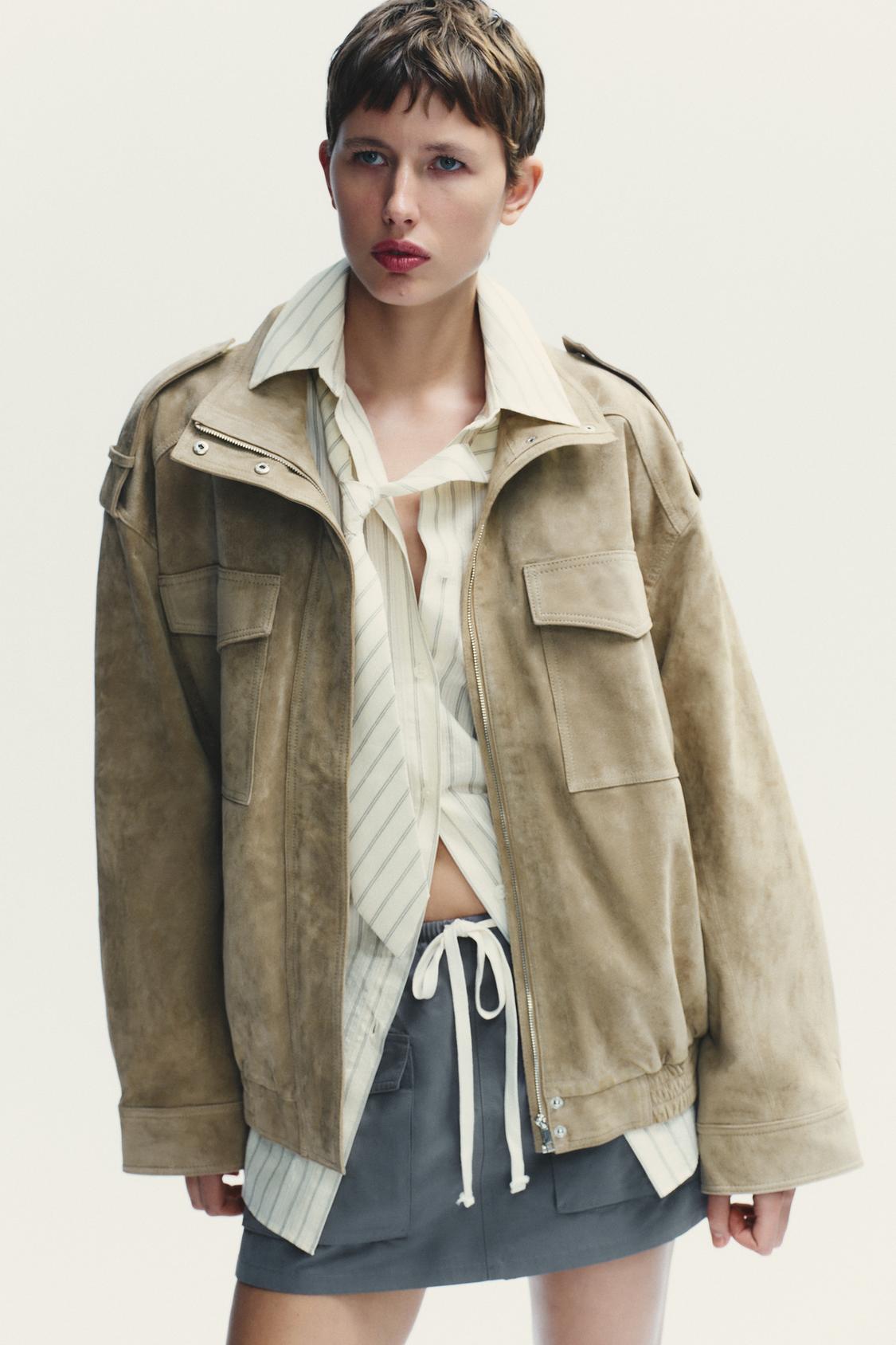 Elevate your style with this Suede Leather Jacket, featuring a high collar for added warmth and sophistication. The long cuffed sleeves with shoulder tabs add a touch of rugged elegance, while front and chest flap pockets combine functionality with fashion. The zip-up front is secured with a snap-button placket, ensuring both convenience and a sleek finish. Perfect for layering, this jacket offers a timeless look that effortlessly enhances any outfit.