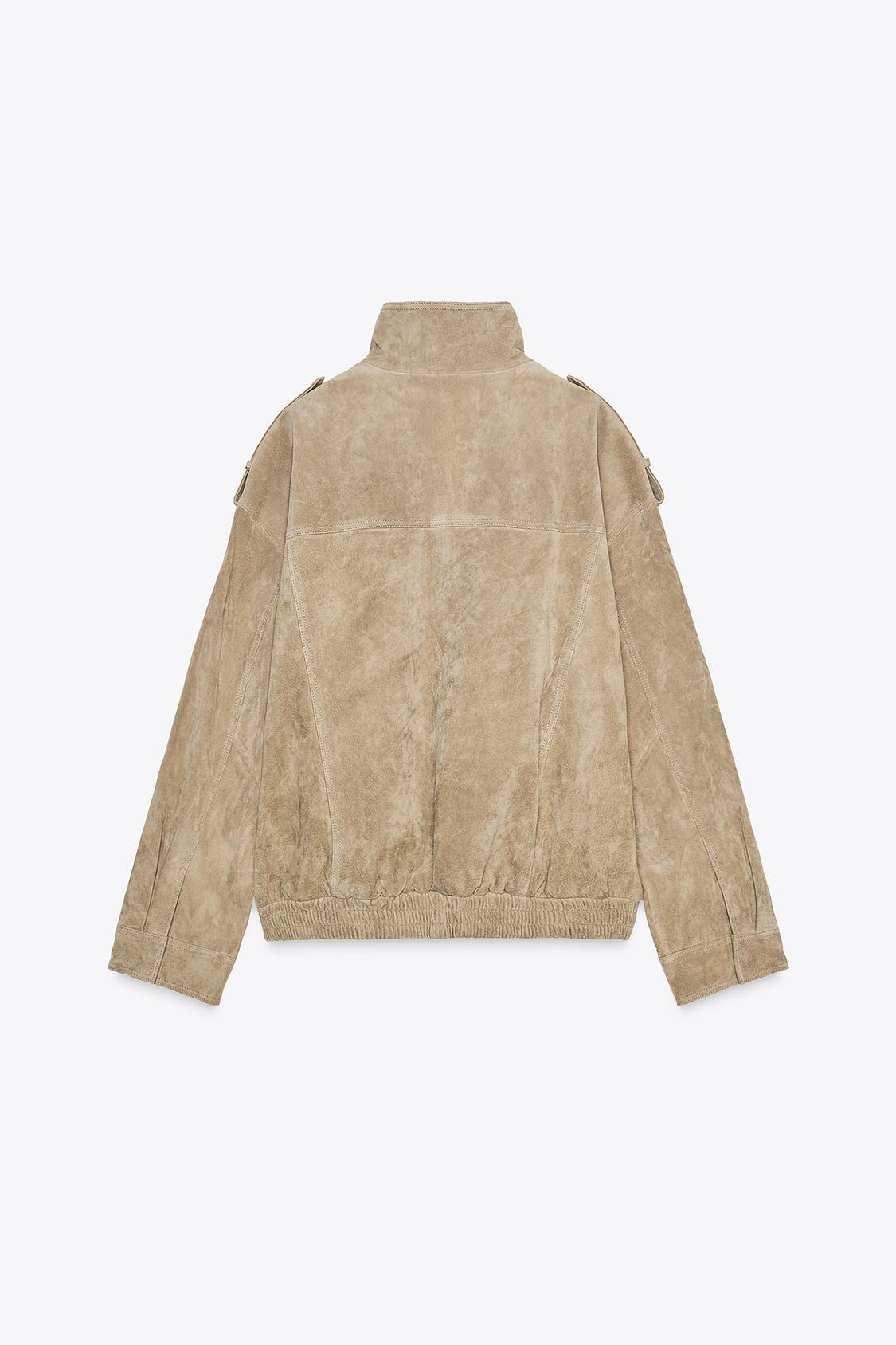 Elevate your style with this Suede Leather Jacket, featuring a high collar for added warmth and sophistication. The long cuffed sleeves with shoulder tabs add a touch of rugged elegance, while front and chest flap pockets combine functionality with fashion. The zip-up front is secured with a snap-button placket, ensuring both convenience and a sleek finish. Perfect for layering, this jacket offers a timeless look that effortlessly enhances any outfit.