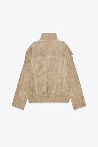 Elevate your style with this Suede Leather Jacket, featuring a high collar for added warmth and sophistication. The long cuffed sleeves with shoulder tabs add a touch of rugged elegance, while front and chest flap pockets combine functionality with fashion. The zip-up front is secured with a snap-button placket, ensuring both convenience and a sleek finish. Perfect for layering, this jacket offers a timeless look that effortlessly enhances any outfit.