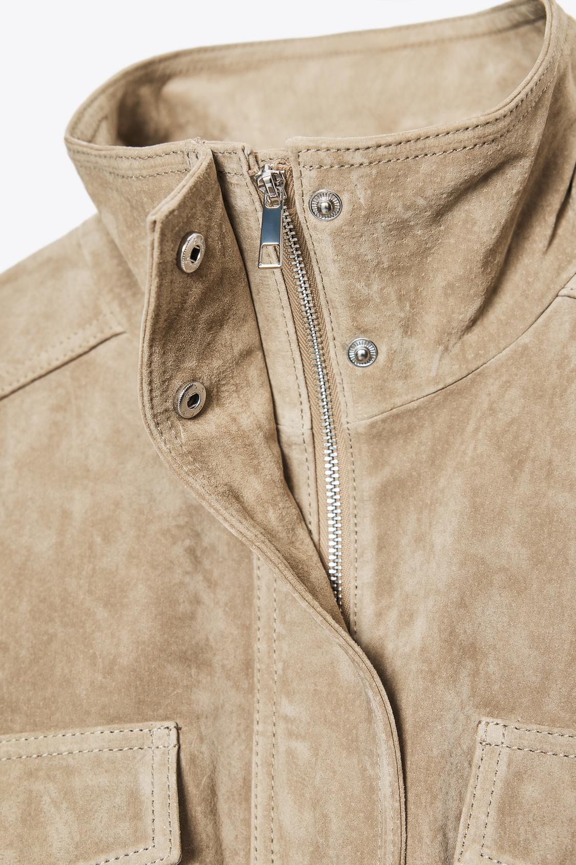 Elevate your style with this Suede Leather Jacket, featuring a high collar for added warmth and sophistication. The long cuffed sleeves with shoulder tabs add a touch of rugged elegance, while front and chest flap pockets combine functionality with fashion. The zip-up front is secured with a snap-button placket, ensuring both convenience and a sleek finish. Perfect for layering, this jacket offers a timeless look that effortlessly enhances any outfit.