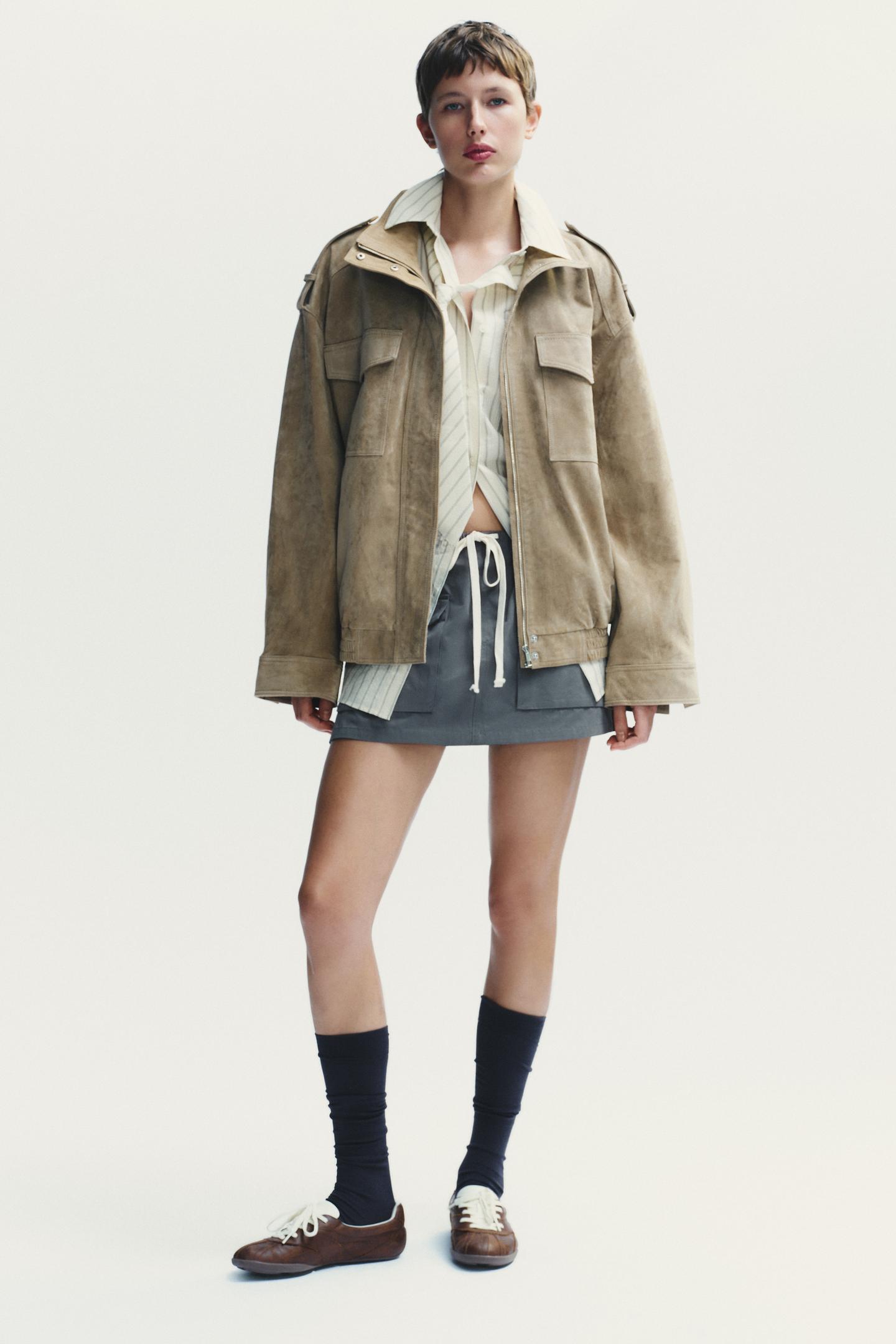 Elevate your style with this Suede Leather Jacket, featuring a high collar for added warmth and sophistication. The long cuffed sleeves with shoulder tabs add a touch of rugged elegance, while front and chest flap pockets combine functionality with fashion. The zip-up front is secured with a snap-button placket, ensuring both convenience and a sleek finish. Perfect for layering, this jacket offers a timeless look that effortlessly enhances any outfit.