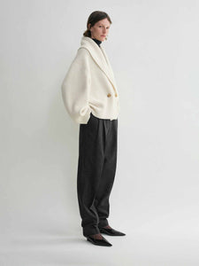 Elevate your layering with this oversized shawl-lapel cardigan by Toteme. Crafted from soft ribbed wool, it offers warmth and cozy comfort while its wide armholes and sleeves ensure effortless movement. The crossed front with button fastening adds a stylish, secure fit, and the curved shawl lapels bring a sophisticated touch to any outfit. Perfect for chic, relaxed days or cozy evenings indoors.