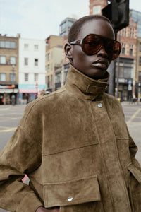 Bomber-style jacket made from 100% leather. Features a lapel collar and long sleeves. Front patch pockets with buttoned flaps. Concealed zip and snap-button fastening at the front.