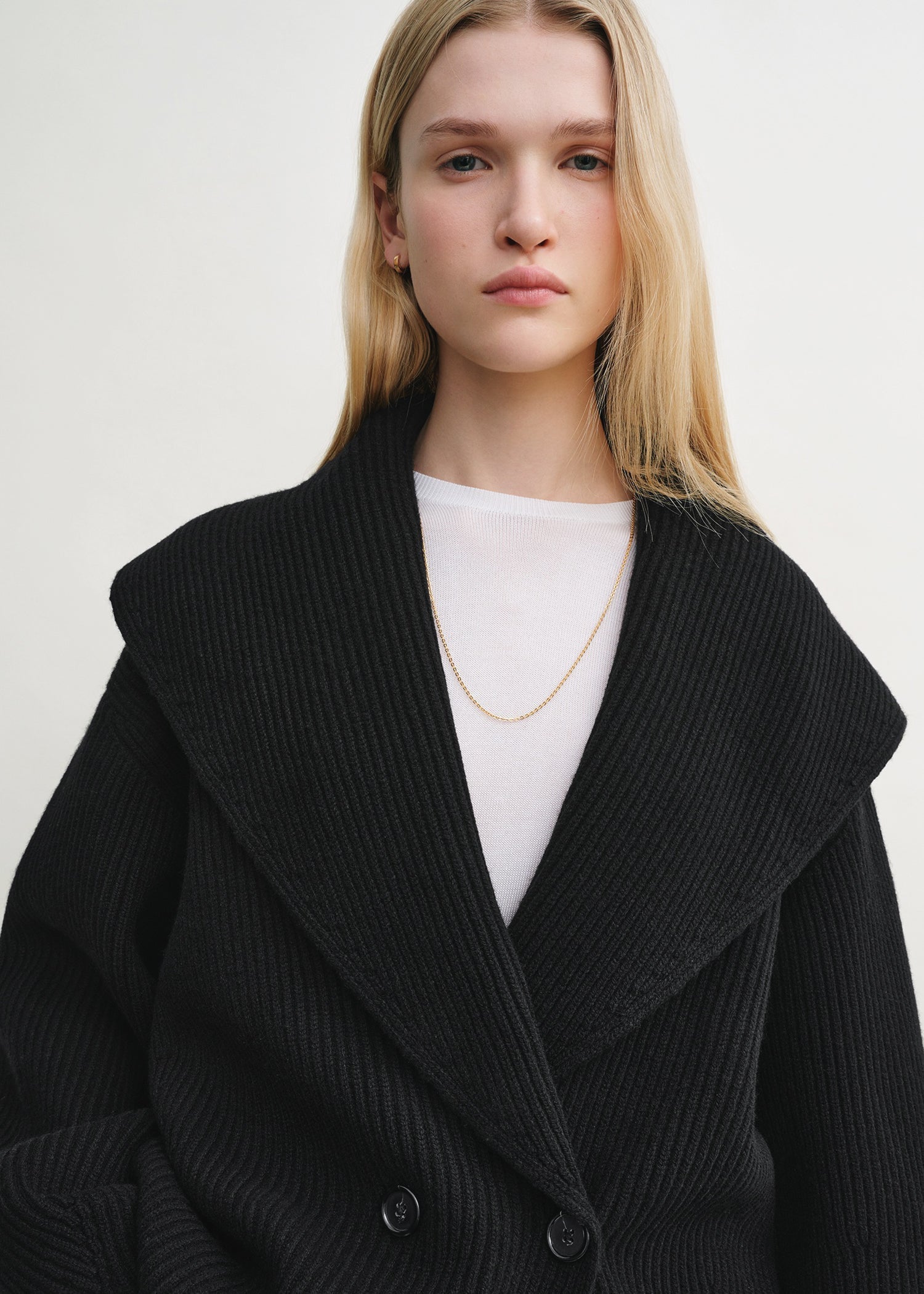 Elevate your layering with this oversized shawl-lapel cardigan in black by Toteme. Crafted from soft ribbed wool, it offers warmth and cozy comfort while its wide armholes and sleeves ensure effortless movement. The crossed front with button fastening adds a stylish, secure fit, and the curved shawl lapels bring a sophisticated touch to any outfit. Perfect for chic, relaxed days or cozy evenings indoors.