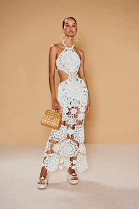 Be a true vision in the Accalia Crochet Gown by Cult Gaia. This masterpiece features hand-crocheted geometric and floral patterns, cutouts at the waist, and a halter neckline for an elegant and alluring look. The open back and adjustable neck tie allow for a perfect fit. Turn heads in this ankle-length gown!