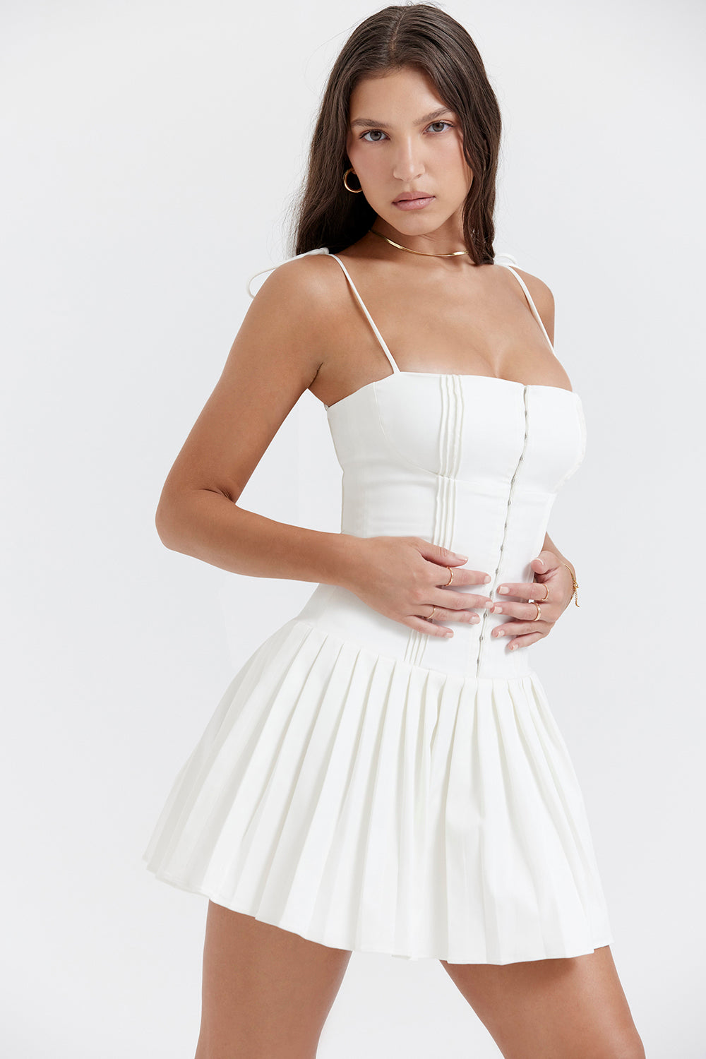 Add some summer fun to your wardrobe with "Marcy"! This mini A-line dress features a playful pleated skirt and a ruched bodice, making it perfect for birthday parties, vacations, and nights out. Its zippered back and full lining ensure comfort, while the "Lola" white heels add a touch of elegance. Cheers to sunny days!