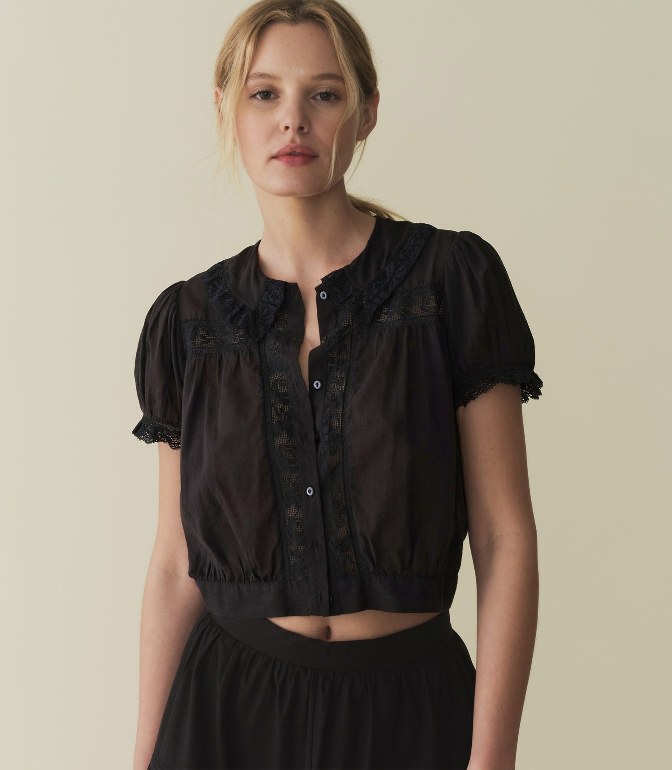 In 100% organic cotton, the ‘30s-inspired Skylark Top features short puff sleeves, antique-inspired lace, and a banded hem that hits at the natural waist for a cropped fit. Mother-of-pearl buttons down the center add a final touch of sweetness.