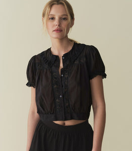 In 100% organic cotton, the ‘30s-inspired Skylark Top features short puff sleeves, antique-inspired lace, and a banded hem that hits at the natural waist for a cropped fit. Mother-of-pearl buttons down the center add a final touch of sweetness.