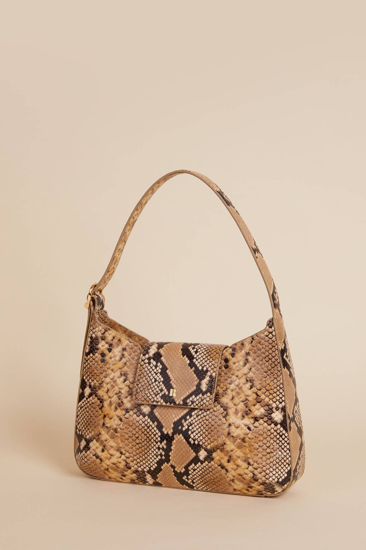 Get a stylish edge with Sac Bobo Python, a faux python leather bag. Its shoulder strap, magnetic flap, and zip closure under the flap make it practical for everyday use. You'll also love the added convenience of an interior mirror.