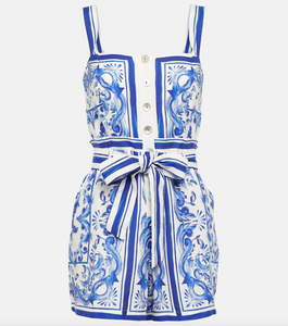 Expertly crafted from a luxurious linen blend, the Printed Romper by Farm Rio features a beautiful Garden Tiles Off-White designer color. With convenient side slit pockets, this romper combines style and function for a versatile and chic addition to your wardrobe.
