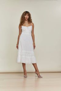 Indulge in luxury with our Petites Landon Dress. Delicate smocking and intricate lace details create a unique and elegant look. Adjustable straps and a front tie provide a tailored fit, making this dress a wardrobe essential for any occasion. Elevate your style with this sophisticated and exclusive piece.