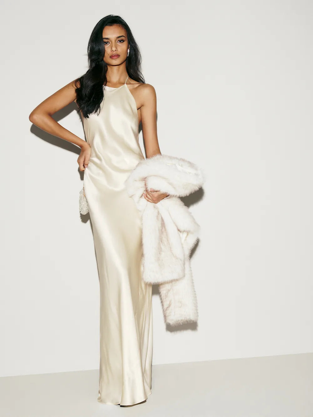 The Jeany Silk Dress by Reformation features adjustable straps and a flattering halter neckline, with elegant back buttons and bias stitching that enhances its fluid silhouette. Designed to graze the floor when paired with heels, this dress offers a graceful, elongated look—hemming may be needed to perfectly suit your height. Ties in the back provide a customizable fit, making it both stunning and comfortable for any special occasion.