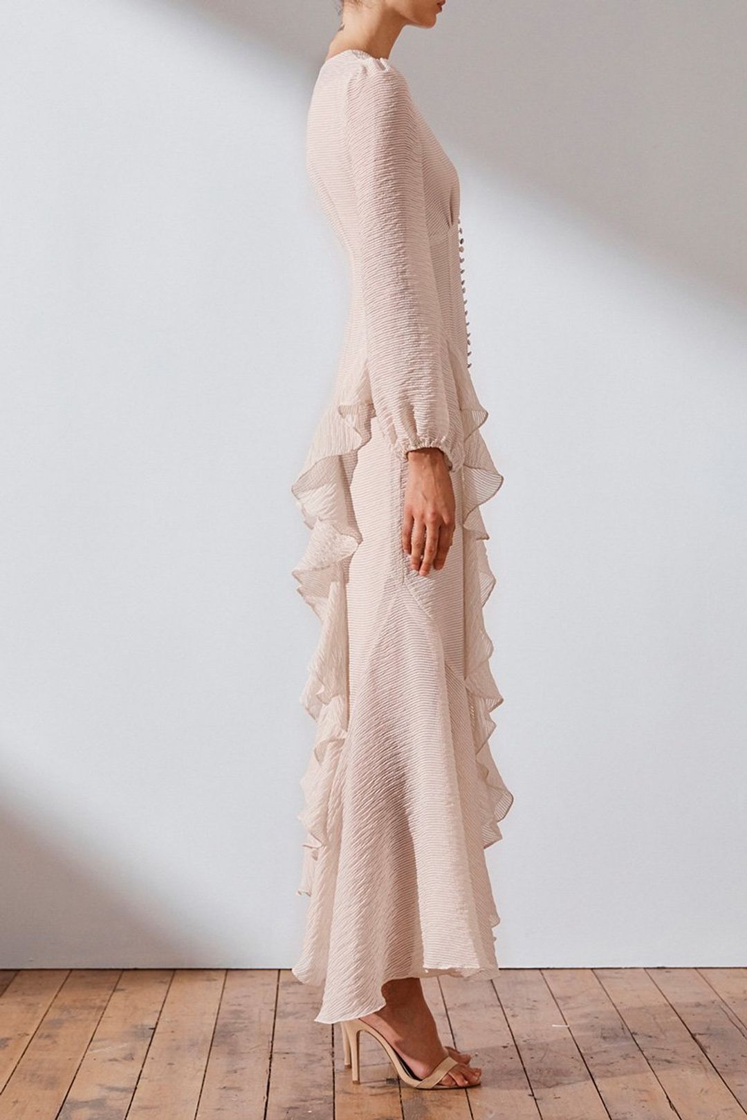Get ready to turn heads in the Charlotte Ruffle Dress by Shona Joy! This stunning dress boasts a plunging V-neckline, blouson sleeves, and charming ruffle details. Perfect for a romantic and feminine look, pair it with hoop earrings and stilettos for a show-stopping ensemble.