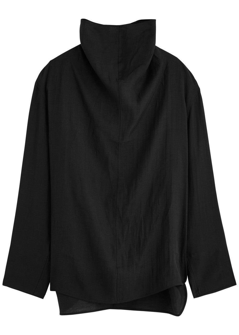 Elevate your wardrobe with this draped woven blouse by Toteme featuring a sophisticated funnel neck and relaxed dropped shoulders for effortless style. The curved hem with a longer back adds a contemporary silhouette, while the detachable cami lining offers versatility and comfort. Perfect for both casual and polished looks, this blouse combines elegance with adaptable wearability.