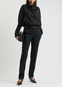 Elevate your wardrobe with this draped woven blouse by Toteme featuring a sophisticated funnel neck and relaxed dropped shoulders for effortless style. The curved hem with a longer back adds a contemporary silhouette, while the detachable cami lining offers versatility and comfort. Perfect for both casual and polished looks, this blouse combines elegance with adaptable wearability.