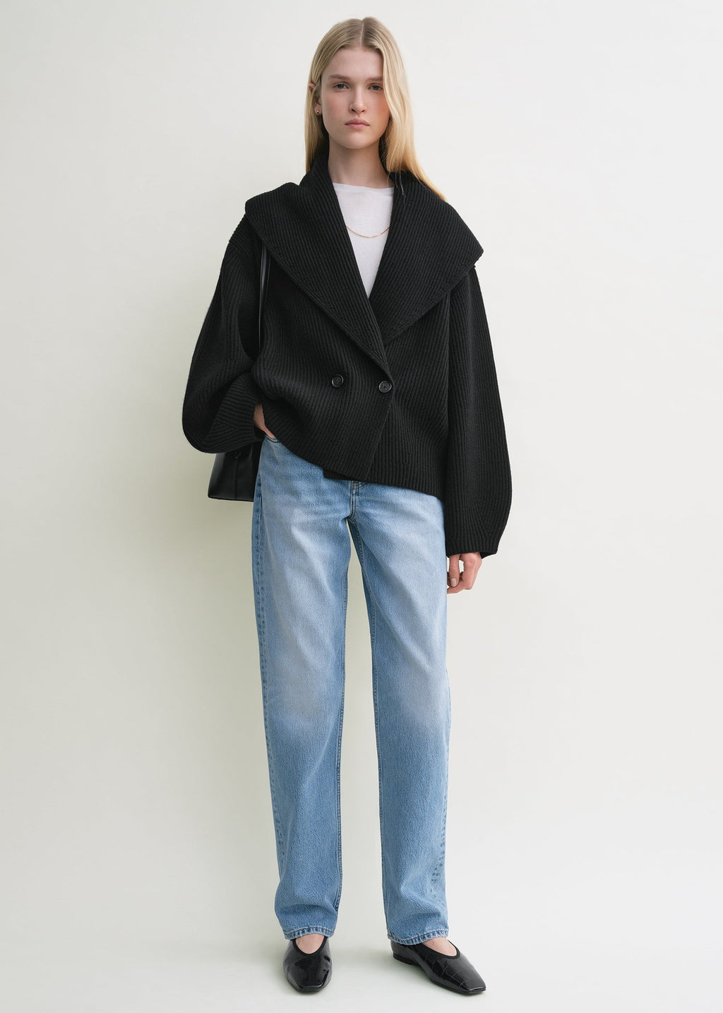 Elevate your layering with this oversized shawl-lapel cardigan in black by Toteme. Crafted from soft ribbed wool, it offers warmth and cozy comfort while its wide armholes and sleeves ensure effortless movement. The crossed front with button fastening adds a stylish, secure fit, and the curved shawl lapels bring a sophisticated touch to any outfit. Perfect for chic, relaxed days or cozy evenings indoors.
