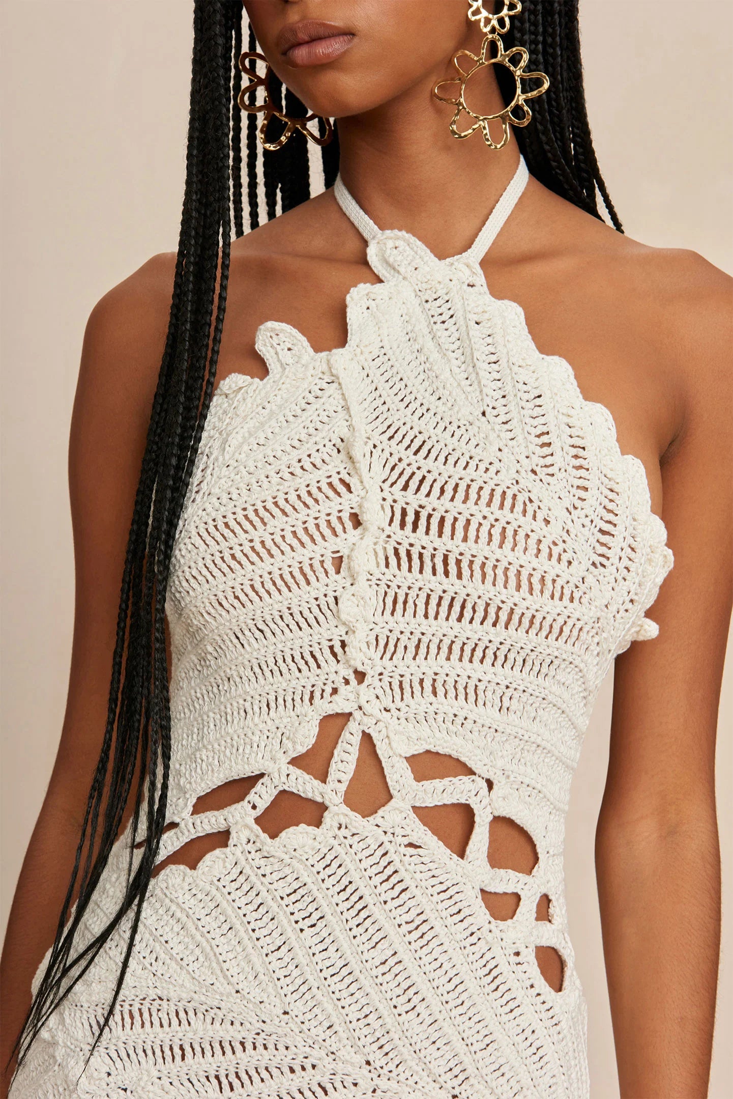 Elevate your summer style with the Undina Crochet Dress by Cult Gaia! Hand-crocheted with intricate leaf motifs, this mini-length halter dress features an open back and adjustable ties for a customizable fit. Feel confident and chic in this unique, one-of-a-kind piece.