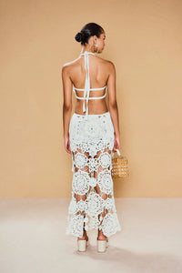 Be a true vision in the Accalia Crochet Gown by Cult Gaia. This masterpiece features hand-crocheted geometric and floral patterns, cutouts at the waist, and a halter neckline for an elegant and alluring look. The open back and adjustable neck tie allow for a perfect fit. Turn heads in this ankle-length gown!