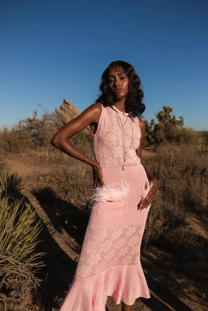 Make a statement with Andreeva's Knit Midi Dress, adorned with delicate feathers. The elegant round neck and figure-flattering design exude sophistication, perfect for any occasion. Elevate your style with heels or go for a more casual look with sandals or sneakers. Be confident and chic in this must-have dress.