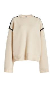 Embrace effortless Scandinavian style with this white wool-cashmere sweater by Totême. Crafted in a wide silhouette from mid-weight wool blended with cashmere, it offers cozy warmth and a soft touch. Intricate contrasting embroidery along the shoulders and armholes adds a refined, artisanal detail, elevating your everyday knitwear with subtle sophistication. Perfect for those who appreciate modern minimalism infused with a unique, handcrafted feel.