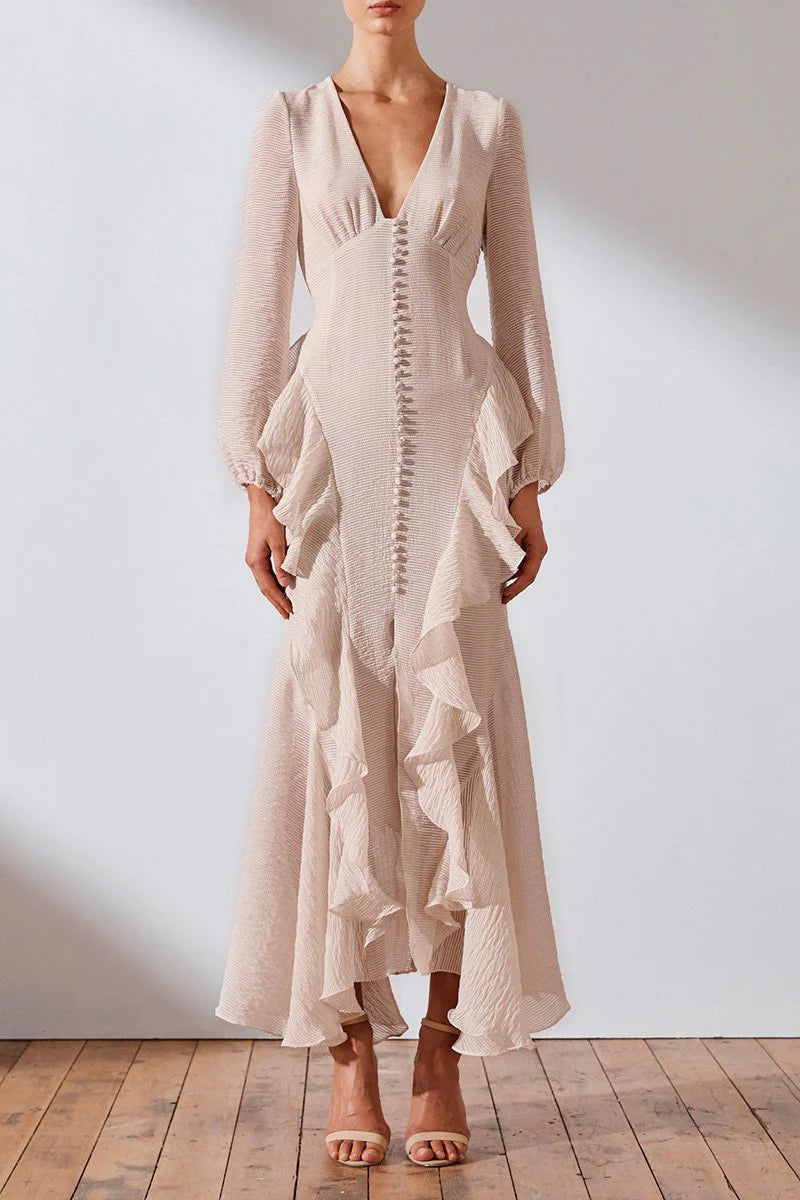 Get ready to turn heads in the Charlotte Ruffle Dress by Shona Joy! This stunning dress boasts a plunging V-neckline, blouson sleeves, and charming ruffle details. Perfect for a romantic and feminine look, pair it with hoop earrings and stilettos for a show-stopping ensemble.