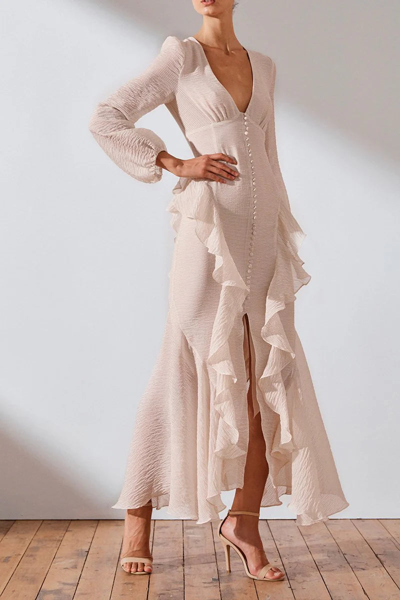 Get ready to turn heads in the Charlotte Ruffle Dress by Shona Joy! This stunning dress boasts a plunging V-neckline, blouson sleeves, and charming ruffle details. Perfect for a romantic and feminine look, pair it with hoop earrings and stilettos for a show-stopping ensemble.