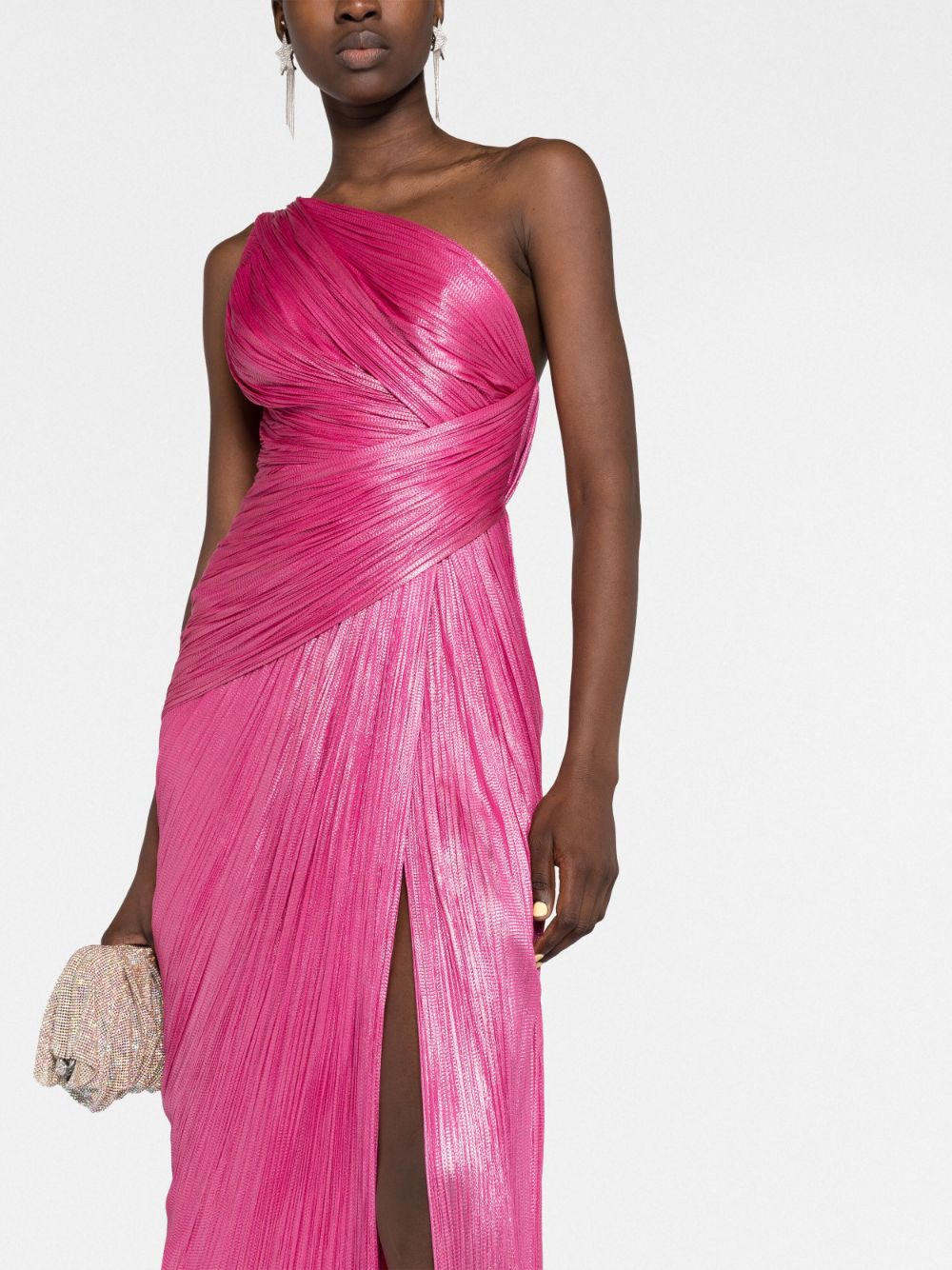 Indulge in luxury and sophistication with Maria Lucia Hohan's Esther One-shoulder Gown. Expertly crafted from lustrous silk, this floor-length gown features a striking metallic raspberry pink hue and a thigh-high slit for a modern touch. With elegant draped detailing, an open back, and a concealed zip fastening, this one-shoulder gown is the perfect addition to your wardrobe collection.