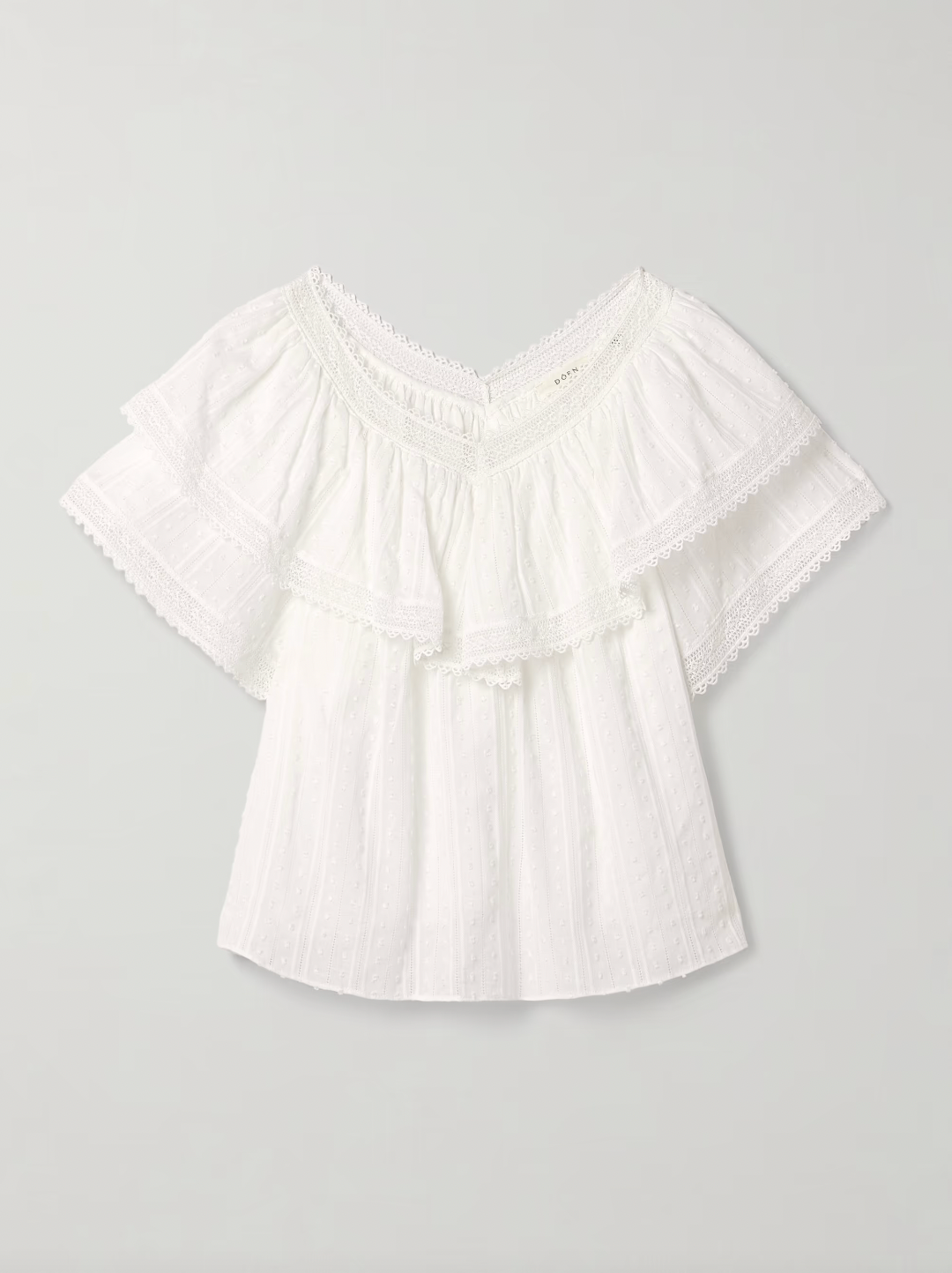 The Cosenza blouse from DÔEN features a delicate fluttery ruffled panel that elegantly highlights the V-neckline and shoulders. Crafted from lightweight fil coupé cotton-voile and accented with airy crochet trims, it offers both comfort and charm. Perfectly versatile, this blouse pairs effortlessly with jeans or flowy skirts, making it a stylish choice for any occasion.