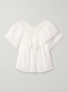 The Cosenza blouse from DÔEN features a delicate fluttery ruffled panel that elegantly highlights the V-neckline and shoulders. Crafted from lightweight fil coupé cotton-voile and accented with airy crochet trims, it offers both comfort and charm. Perfectly versatile, this blouse pairs effortlessly with jeans or flowy skirts, making it a stylish choice for any occasion.