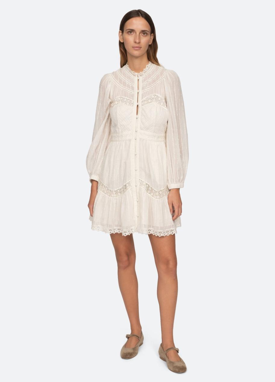 Stay comfortable and chic in the Haven Dress by Sea NY. Crafted from soft cotton, this dress features long puff sleeves, delicate lace insets, and trim detailing. Perfect for a day at the beach or a casual outing, it's a must-have for your wardrobe.