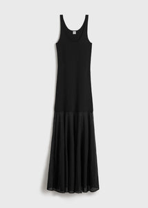 Elevate your evening style with this Black Evening Tank Maxi Dress by Toteme, crafted from a stretchy viscose-blend jersey combined with open-knit viscose for a flattering fit and breathable comfort. Its paneled construction and pleated skirt create graceful movement, while the rib-knit scoop neck and arms add subtle texture. Fixed shoulder straps ensure a secure fit, making this dress an elegant choice for any occasion where sophistication meets ease.