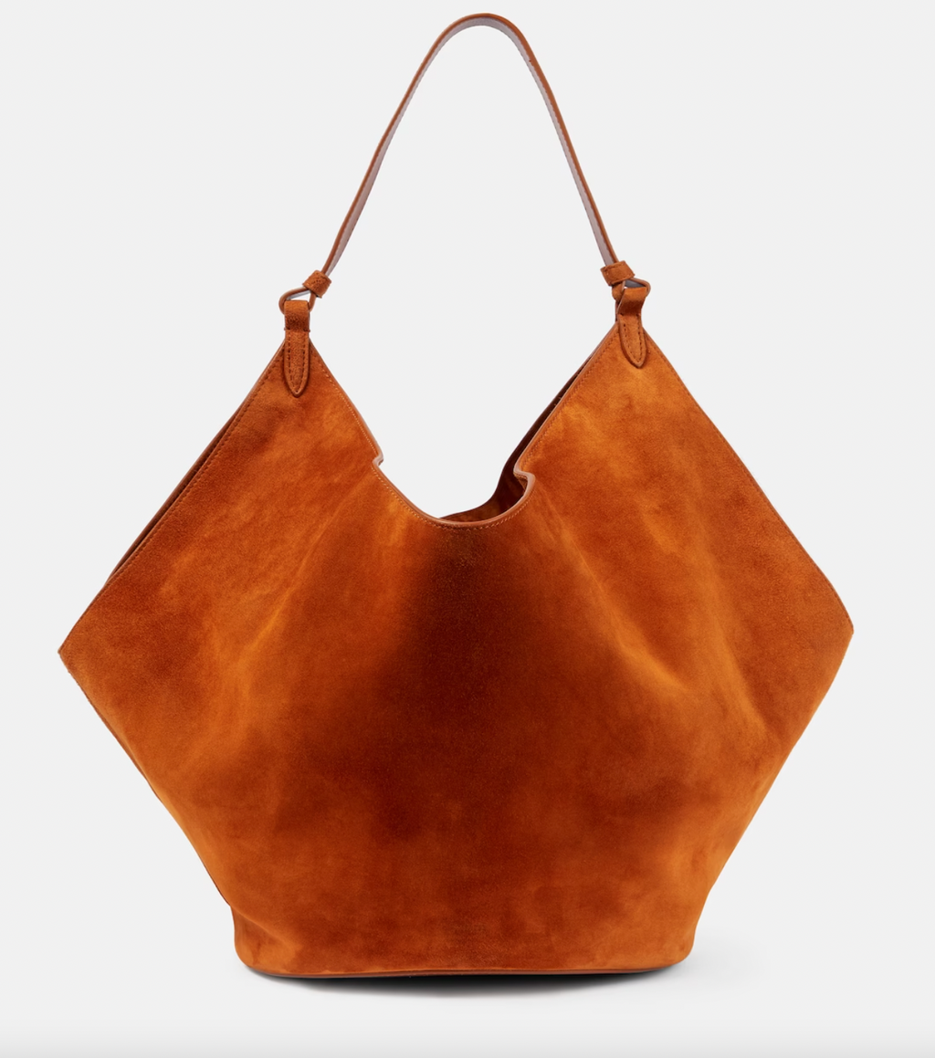 Minimalist in design yet timeless in nature, the medium Lotus suede tote bag from Khaite epitomizes understated luxury. Made in Italy, this scarf-inspired leather design is lightweight and features sculptural folds, as well as a structured base for stability.