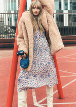 Load image into Gallery viewer, Elevate your style with ease and comfort in this Marant Etoile hooded coat. Crafted with ultra-soft faux-fur and a cozy funnel neck, this beige coat features toggles and side pockets for a functional touch. Perfect for a chic and effortless look. Worn by Emily in Paris.
