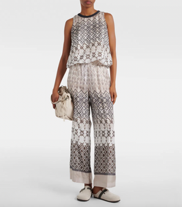 Elevate your wardrobe with the Printed Silk Top by Brunello Cucinelli. This sleeveless top features a playful puffed hem for a flared shape, adding a touch of ethnic whimsy to any outfit. Perfect for those looking for a unique and stylish addition to their wardrobe.