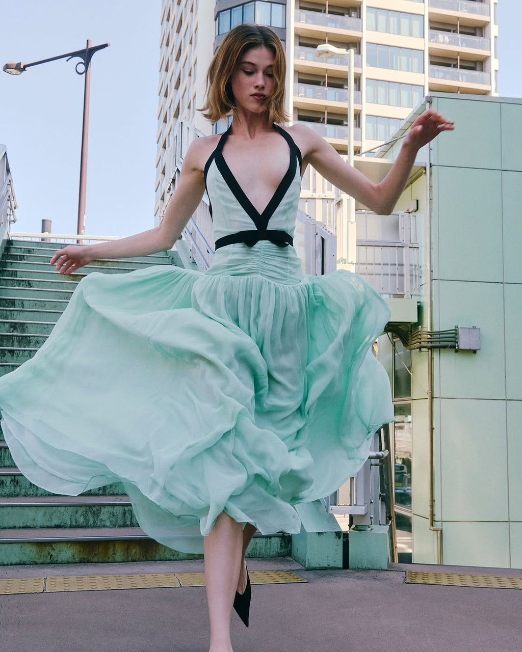 The Siren Dress in Mint by Helsa is engineered for those who embrace bold fashion statements. This sleeveless bodycon maxi features a striking plunging V-neckline and open back that exude confidence and allure. Contrast mesh patchwork adds contemporary visual interest, while pleated skirt detailing creates graceful movement. The secure halter construction delivers support without compromising the dress's daring aesthetic. 