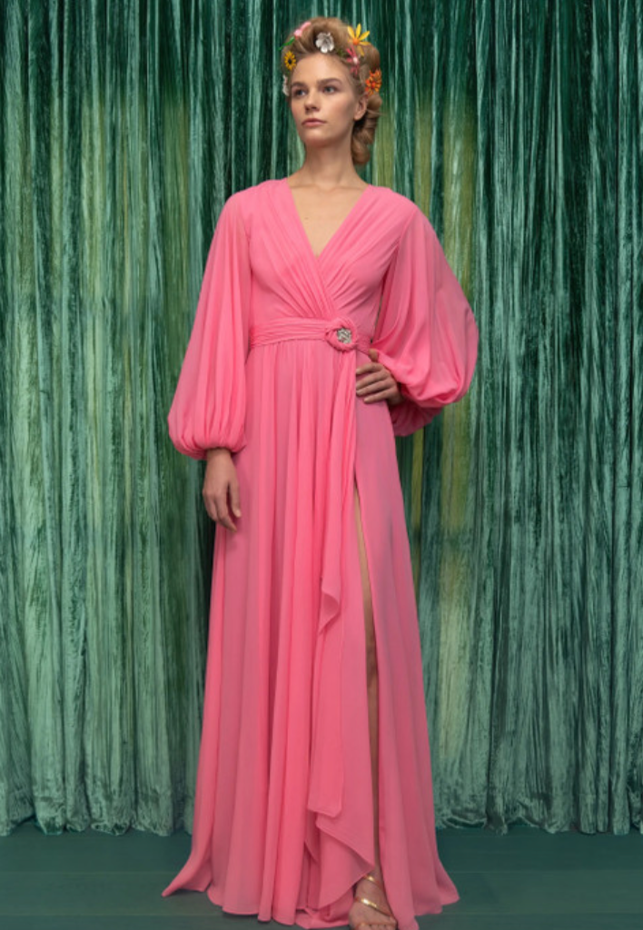 Feel elegant and sophisticated in our REEM ACRA Long Blouson Sleeve Chiffon Gown. This pink vintage party dress features a flattering v-neck and long billowy sleeves for a touch of vintage charm. Adorned with delicate diamond detailing, this gown is perfect for any special occasion.