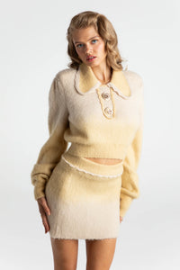 Indulge in ultimate retro-glamour with the Emily Knit Set. Crafted with luxurious alpaca wool yarn, this two piece set features a knit cardigan and bodycon skirt, adorned with intricate stitching and gold custom buttons. Effortlessly chic, the set also includes shoulder pads for added shape. Stay warm and make a statement with this timeless and elegant ensemble.