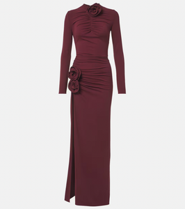 Indulge in this luxurious gown by Magda Butrym with delicate floral appliques and a figure-flattering ruched jersey fabric. Show off your sophisticated sense of style and radiate elegance at any special occasion. Elevate your look with this exclusive gown, perfect for the fashion and art lover in you.