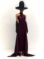 Load image into Gallery viewer, Experience red carpet glamour and drama with the Solace London Rumi Maxi Dress in Plum. This stunning gown is designed to turn heads, with its body-sculpting stretch-crepe fabric and voluminous floor-length hem. The satin-faille wrap detail at the neck and waist adds an extra touch of luxury to this show-stopping dress.
