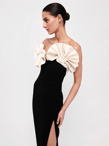 Unleash your inner confidence with the Lavina ruffled dress. Made with a strapless design and bandage material, this midi dress is both elegant and sexy. The black and white color scheme adds a touch of sophistication to any occasion. Feel comfortable, yet stylish with this dress that will hug your curves in all the right places.