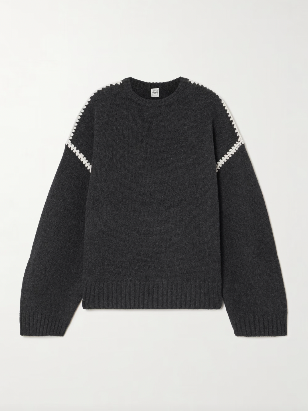 Elevate your wardrobe with this oversized sweater by Toteme crafted from a sumptuous wool and cashmere blend. Its relaxed fit with dropped shoulders offers effortless comfort, while the contrasting cream embroidery adds a refined, distinctive touch. Designed as a timeless staple, it seamlessly enriches your collection, providing both warmth and style for any occasion.