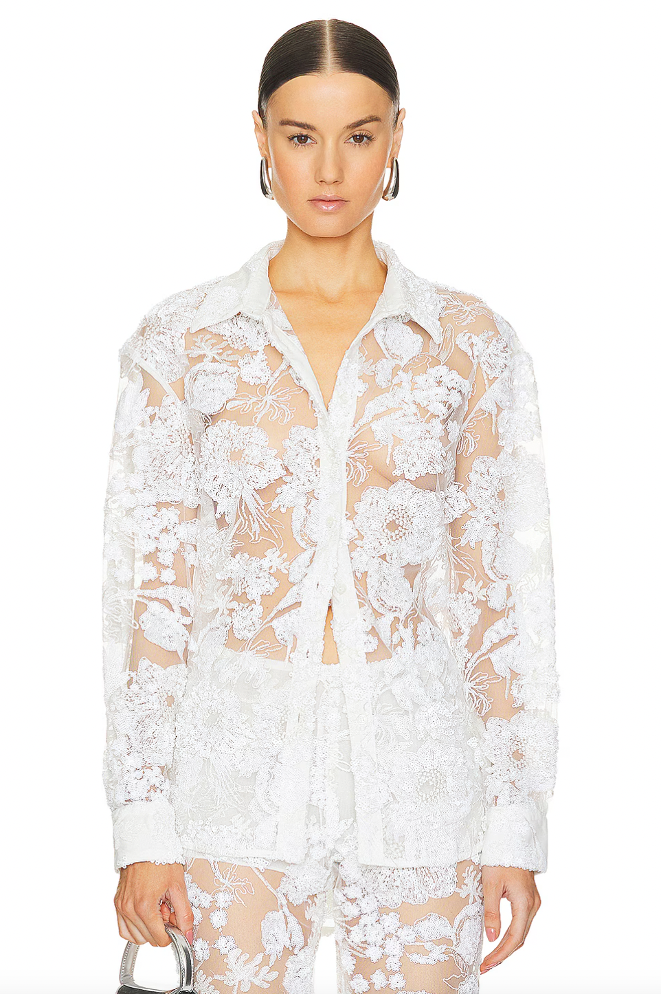 Elevate your wardrobe with our Cara Embroidered Button Down Blouse by AKNVAS. The front button closure makes for easy wear, while the mesh fabric adds a touch of elegance. The sequin embellishments throughout add just the right amount of sparkle to any outfit.