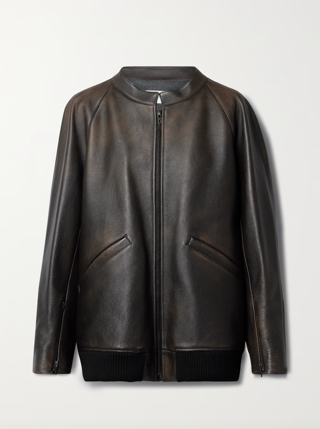 The Row brown oversized motorcycle jacket in distressed calfskin leather with stand collar, raglan sleeves, side welt pockets, and ribbed hem. Finished with silver-toned front and interior cuff zippers. This jacket comes fully lined in silk Habotai.