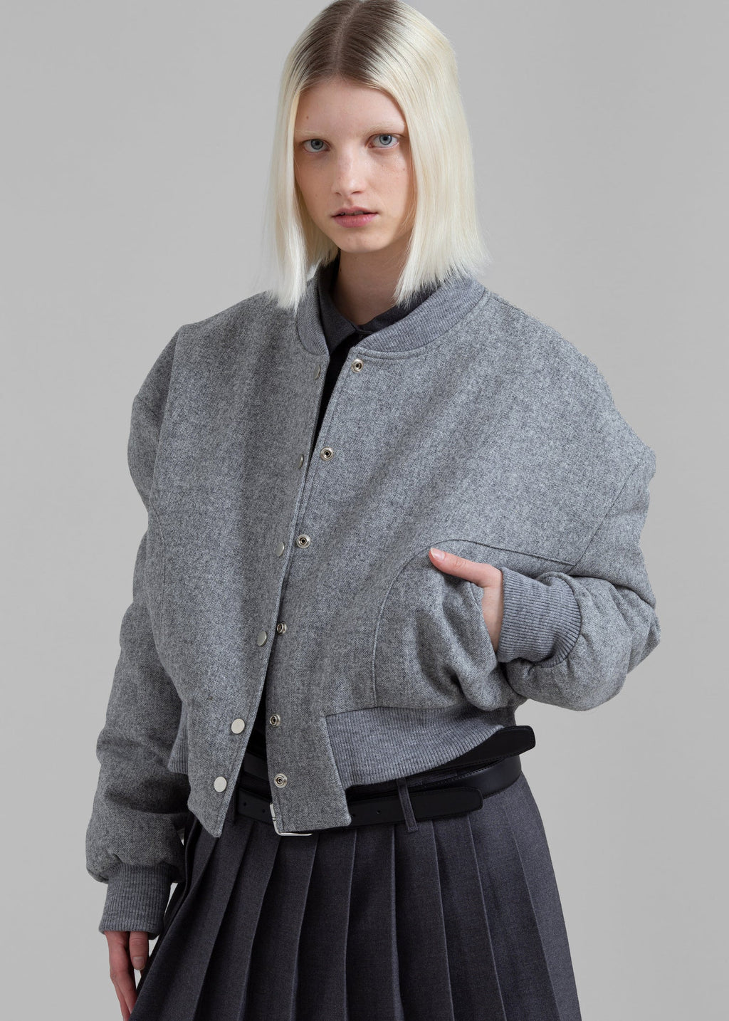 Introducing the Debbie Wool Bomber Jacket by The Frankie Shop, crafted from luxurious midweight woven wool. With a relaxed fit and cropped profile, it exudes an elegant and exclusive style. The ribbed baseball collar, front welted pockets, and elasticated ribbed trim add both sophistication and functionality. Snap up the front button closure for a timeless and tailored look.